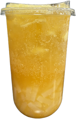 Tall clear cup of cloudy golden piña colada Red Bull with coconut jellies