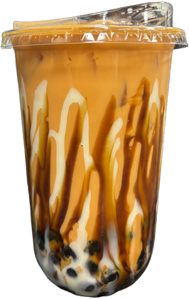 Tall clear cup of Thai black milk tea with cream and brown sugar stripes, tapioca at the bottom