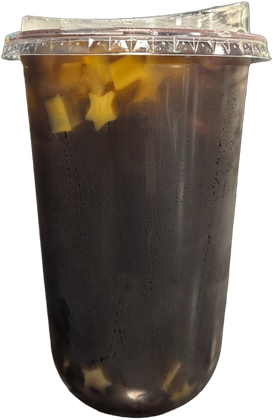 Tall clear cup of deep blueberry green tea with yellow mango star jellies